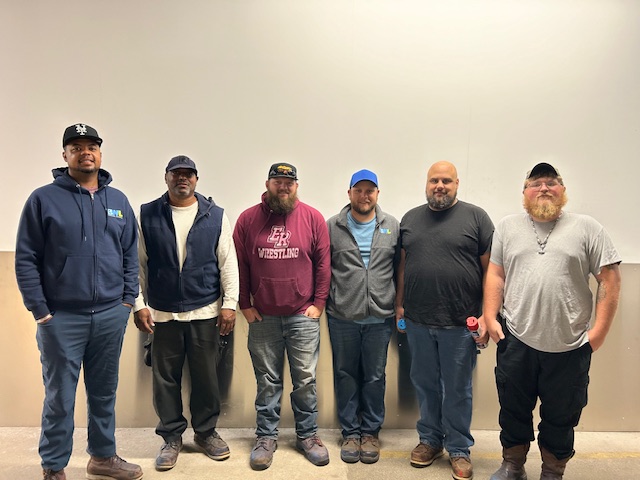 group of six guys standing next to each other smiling for the camera