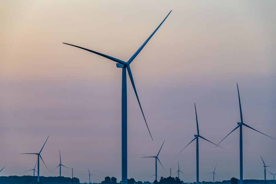 a field of power generating windmills at dusk